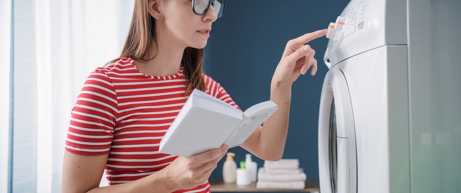 Woman learning how to use her washing machine