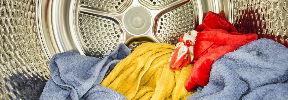 Interior view of tumble dryer with drying clothes
