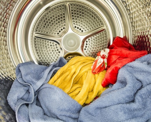 Interior view of tumble dryer with drying clothes