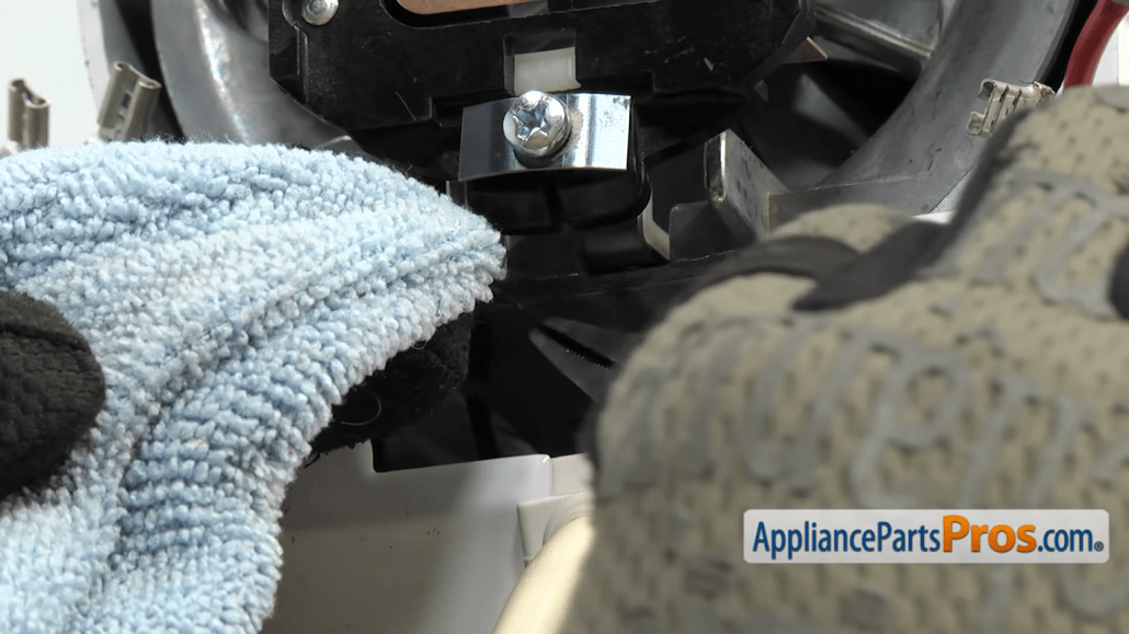 Gloved hands holding a towel inside a KitchenAid mixer