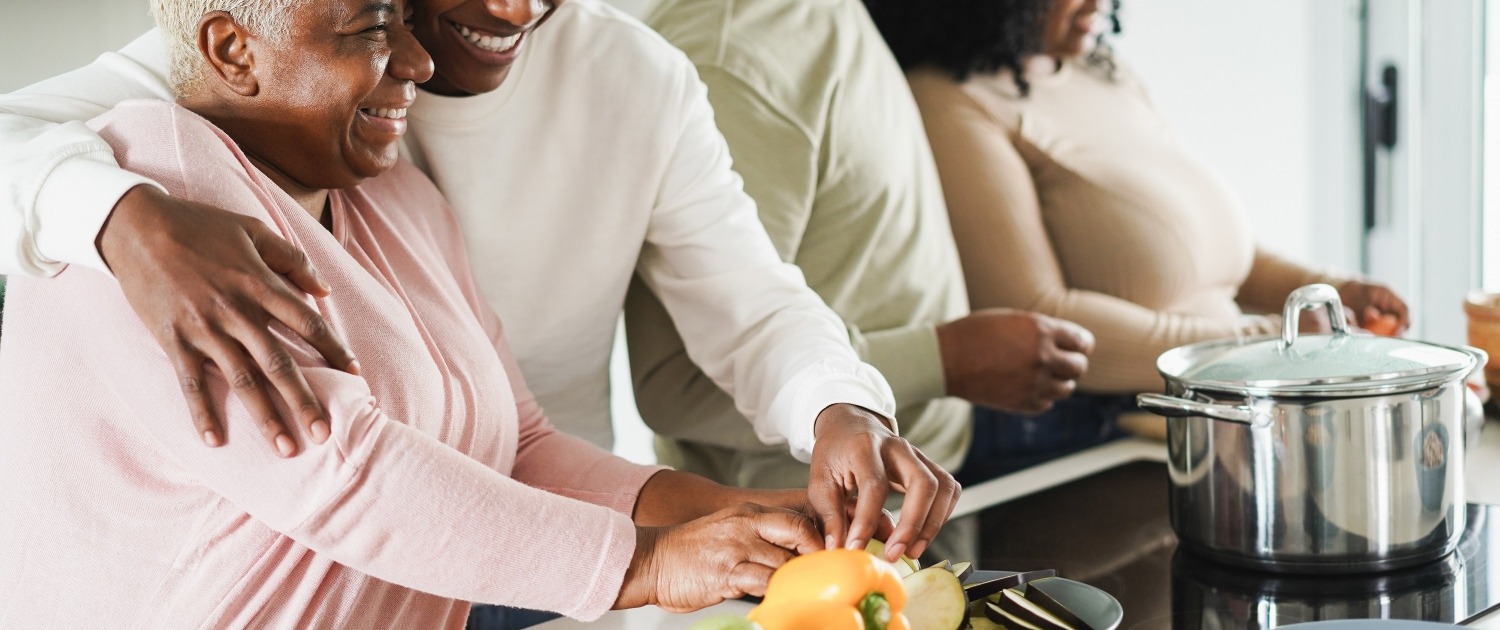Happy black family cooking inside kitchen at home