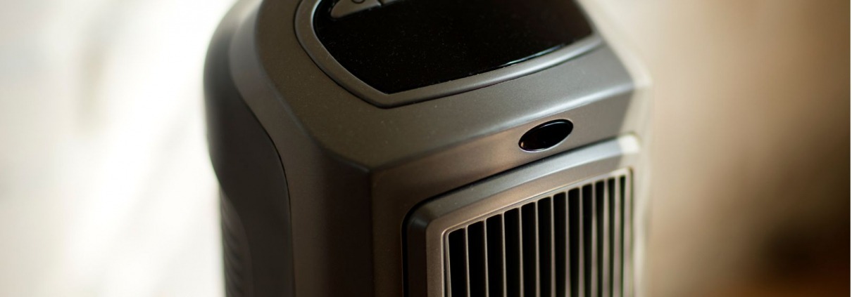 black slim electric portable space heater standing up