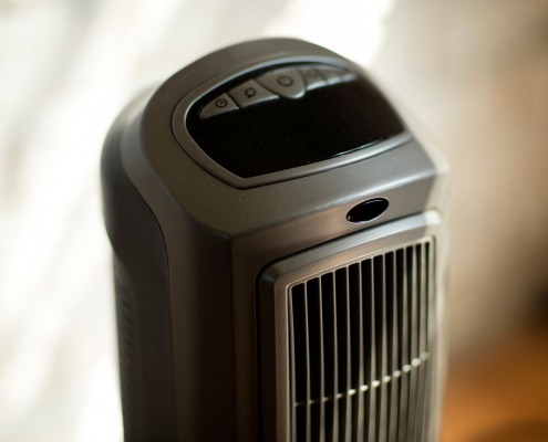 black slim electric portable space heater standing up