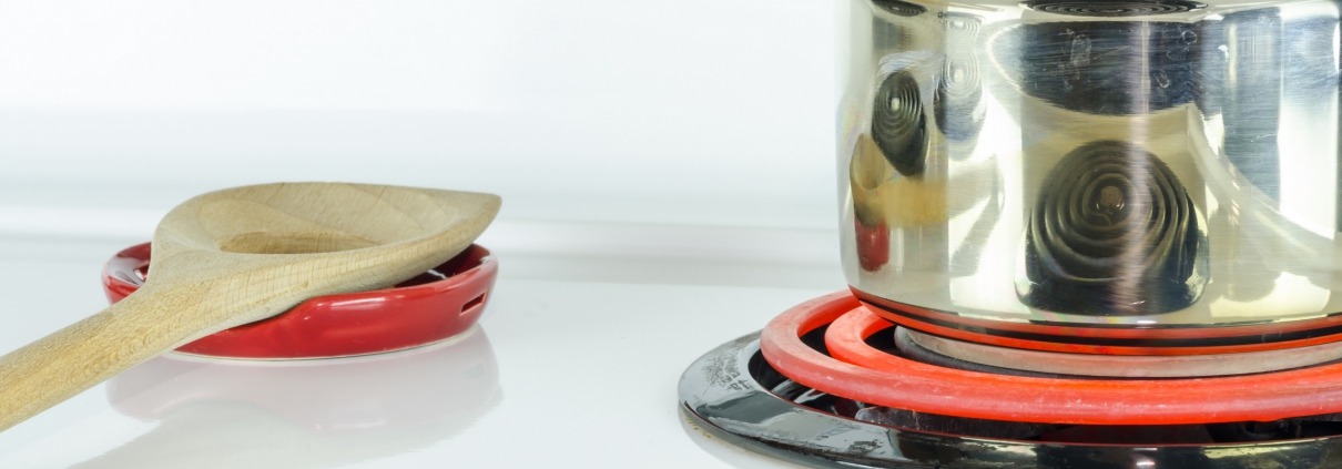 stove top with pot and glowing stove eye
