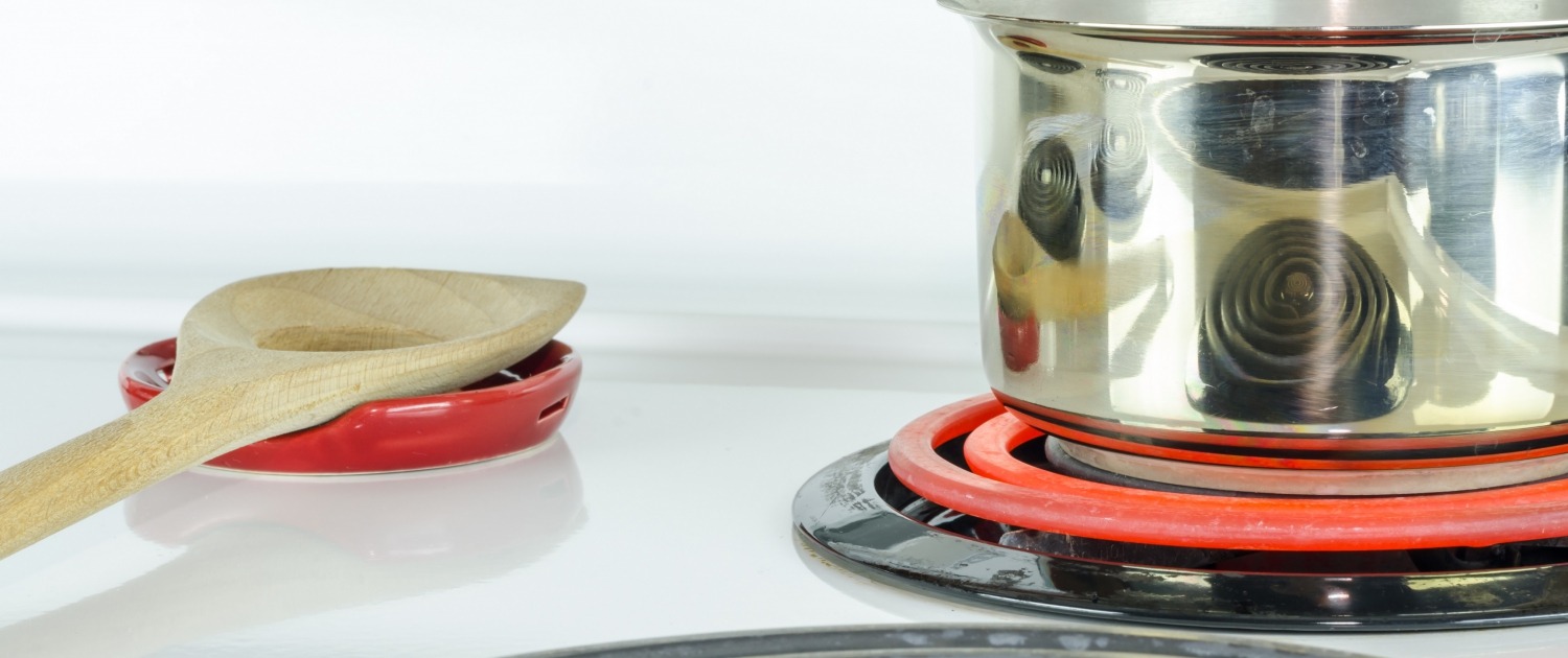 stove top with pot and glowing stove eye