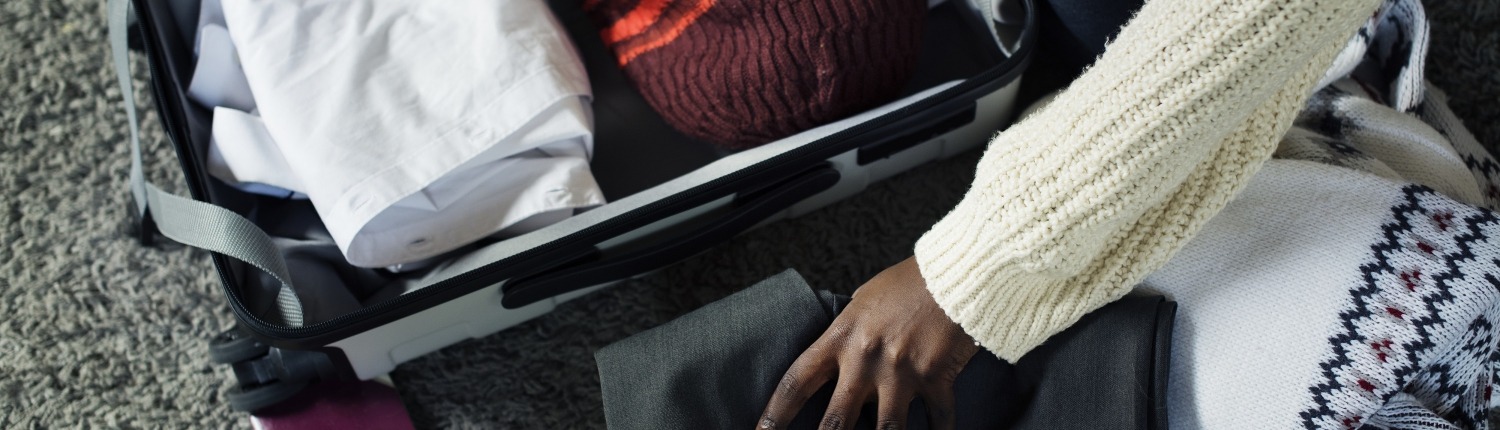 Feminine African American hand packing a suitcase, Image by rawpixel.com on Freepik