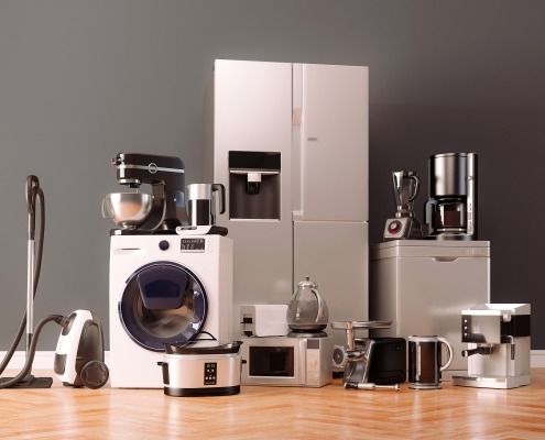 A group of home appliances sitting on a wood floor