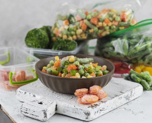Freezer burned peas and carrots on table
