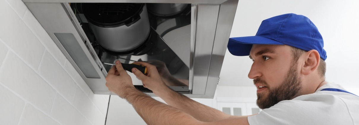 Man Repairing Kitchen Exhaust Fan or Range Hood That Isn't Pulling Air