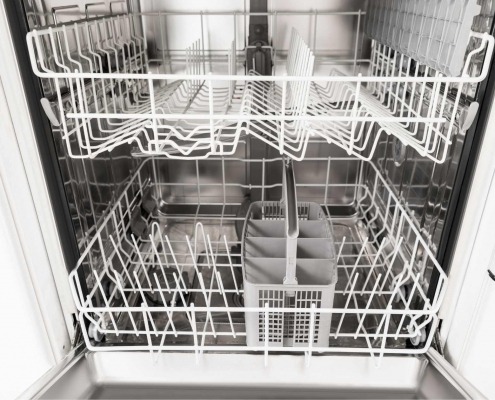 Interior shot of a dishwasher and racks