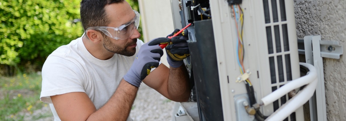young man installing a DIY air conditioning unit