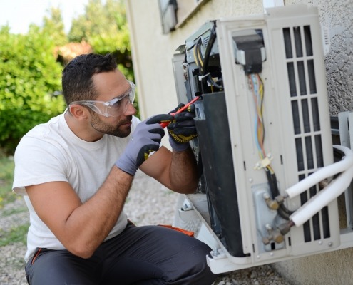 young man installing a DIY air conditioning unit