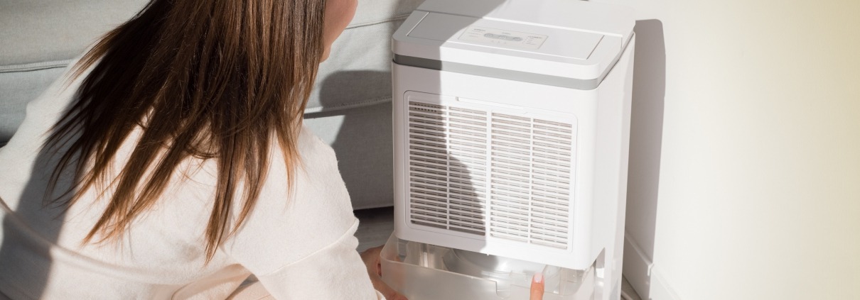 woman troubleshooting a dehumidifier