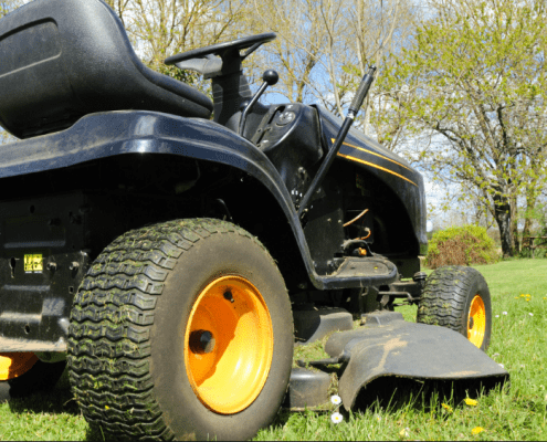 Lawnmower in yard after troubleshooting unever cutting