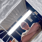 older man looking into chest freezer