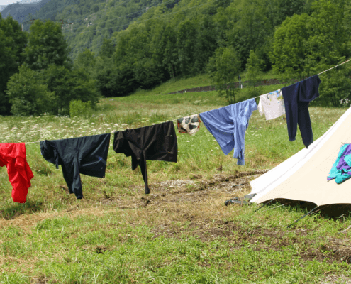 How to Hand Wash Clothes While Camping while drying them on a clothes line