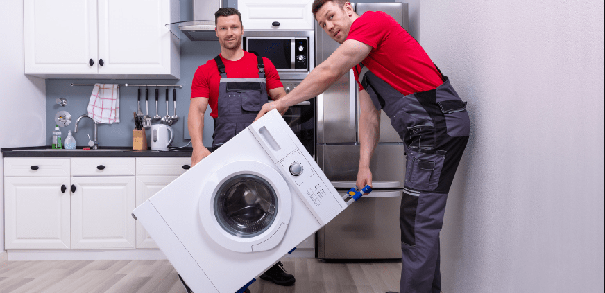 two men moving household appliances on a dolly