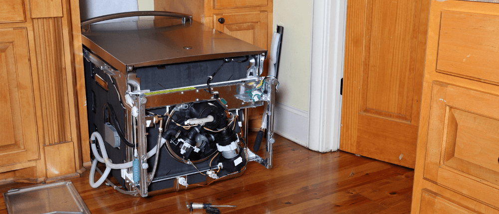 Dishwasher leaned over in kitchen to replace circulation pump and motor