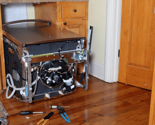 Dishwasher leaned over in kitchen to replace circulation pump and motor