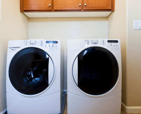 Washing machine and dryer in a laundry room after troubleshooting E10 error code