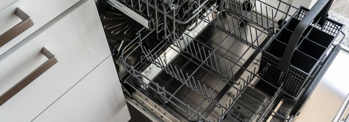 Dishwasher pulled out to inspect dishwasher insulation