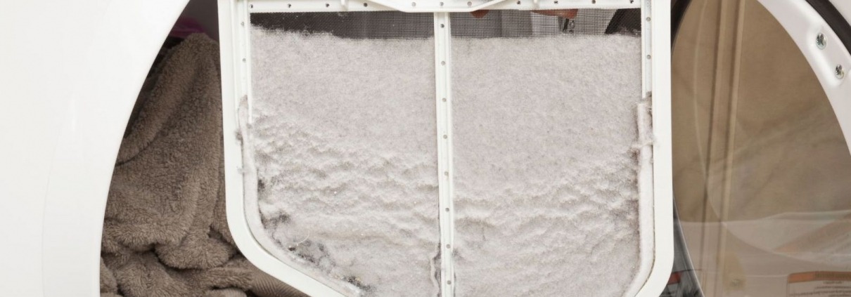 open dryer door with man holding full lint trap