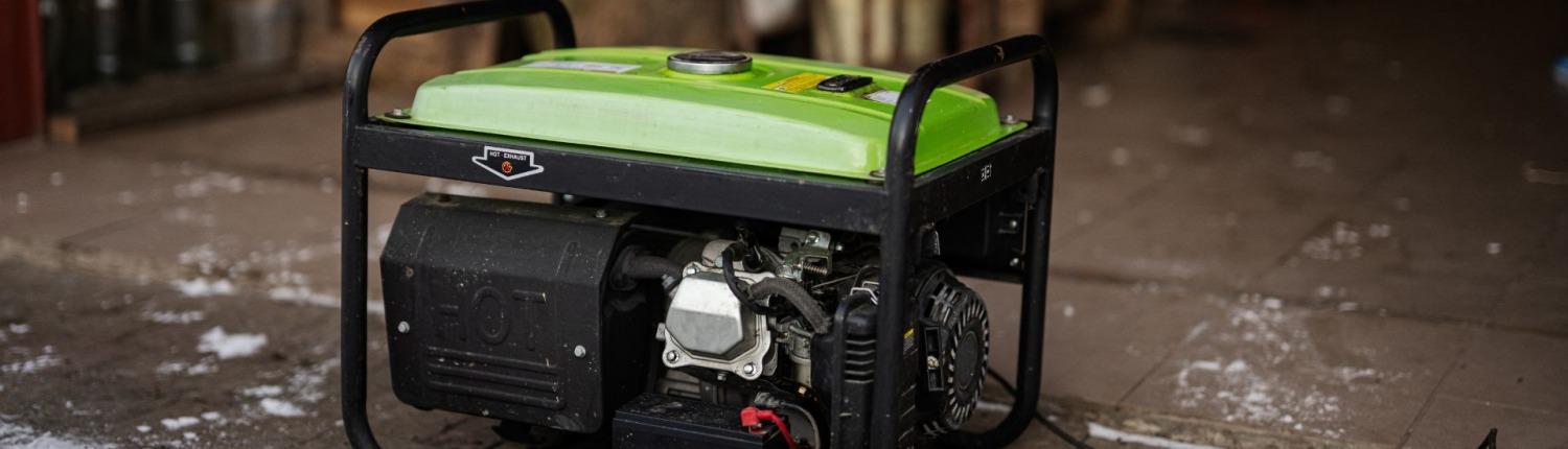 generator resting on garage floor near ice from storm
