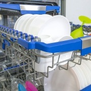 open dishwasher with colorful rack and dishes in kitchen