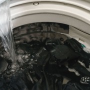 washing machine full of clothes filling up with water