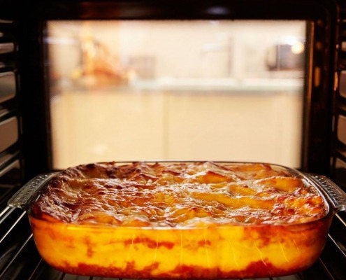 open oven interior with casserole resting on rack