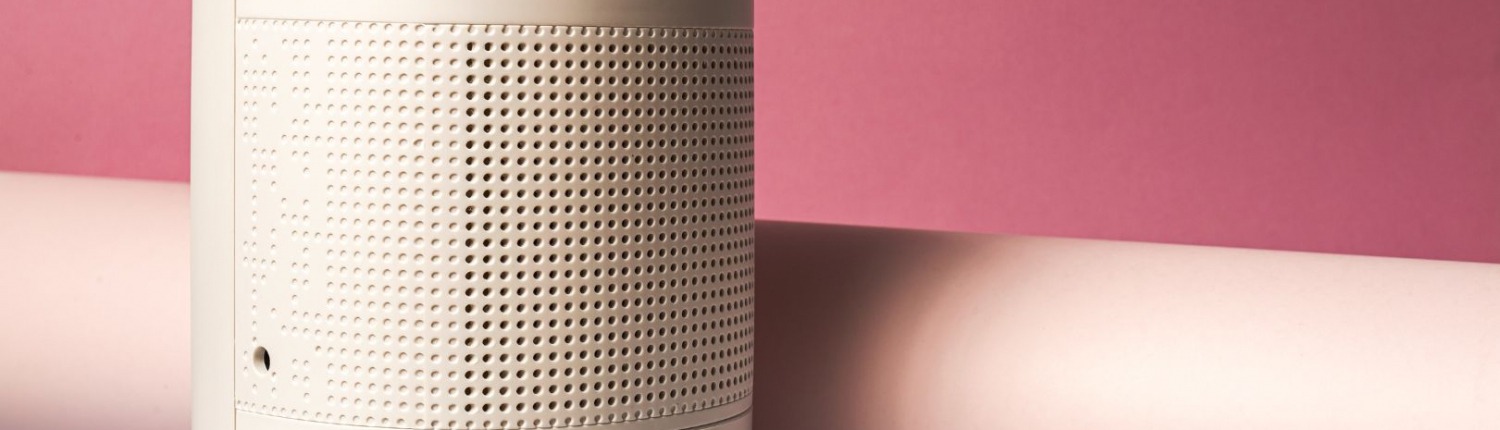 white dehumidifier resting against pink background