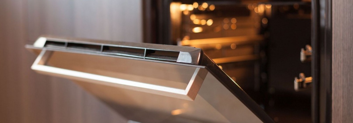 stainless steel oven door open in modern kitchen