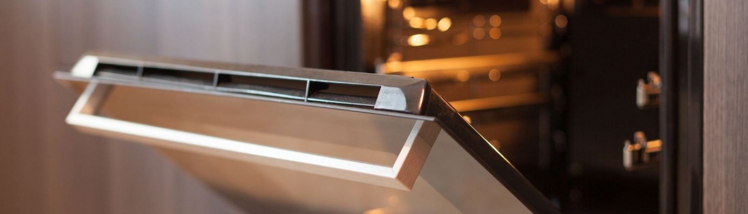 stainless steel oven door open in modern kitchen