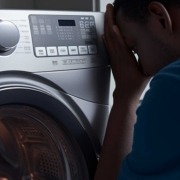 Frustrated man trying to troubleshoot aSamsung Washer E3 Code