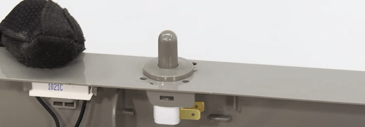 Door switch on a refrigerator being replaced
