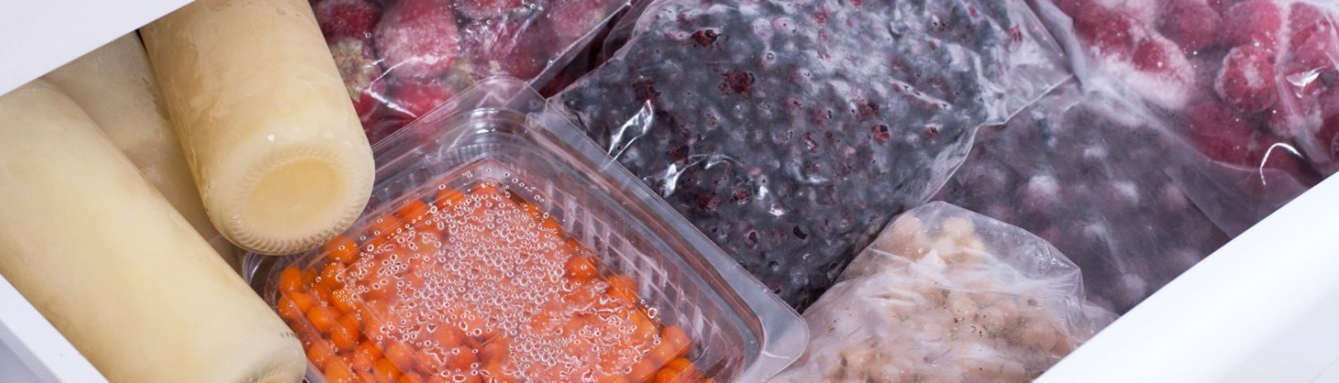 fresh fruits and vegetables sealed in bags within open freezer drawer