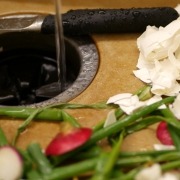 eggshells and vegetable scraps laying next to garbage disposal in kitchen sink