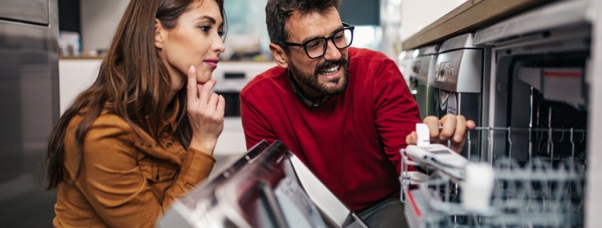 man and woman shopping for a dishwasher