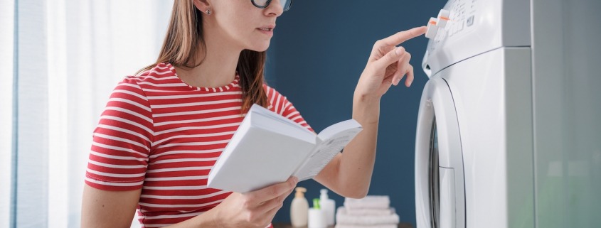 Woman learning how to use her washing machine