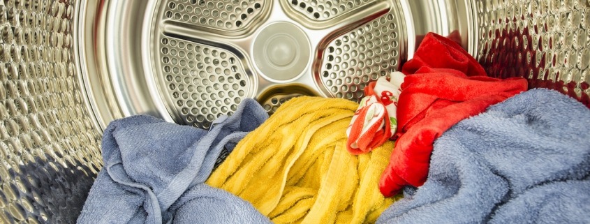 Interior view of tumble dryer with drying clothes