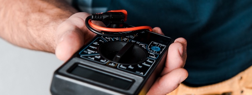 A person holds a multimeter