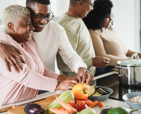 Happy black family cooking inside kitchen at home