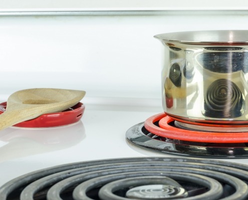 stove top with pot and glowing stove eye