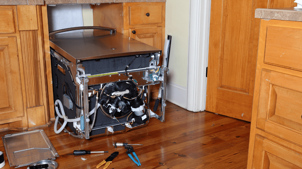 Dishwasher leaned over in kitchen to replace circulation pump and motor