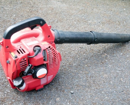 leaf blower unplugged laying on ground