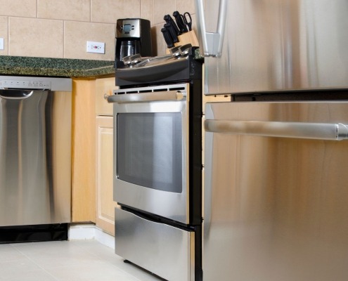 clean and shiny stainless steel appliances in kitchen