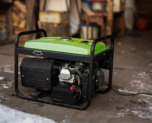 generator resting on garage floor near ice from storm