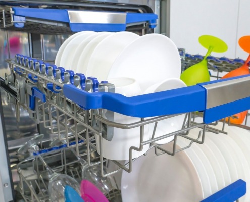 open dishwasher with colorful rack and dishes in kitchen