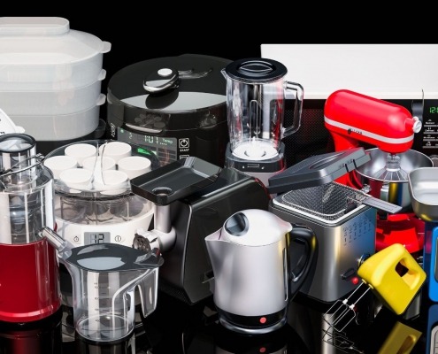 various colored small kitchen appliances displayed on black countertop