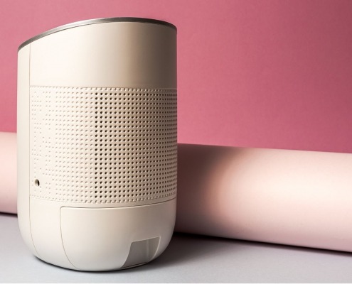 white dehumidifier resting against pink background